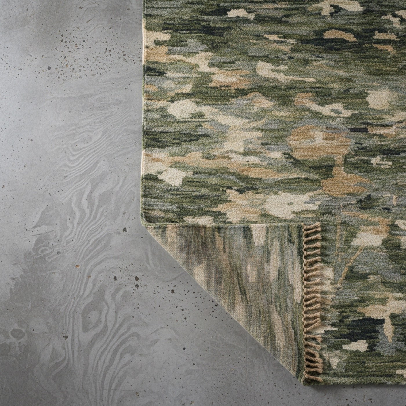 A hand-knotted wool rug across a wide timber floor in a quiet room